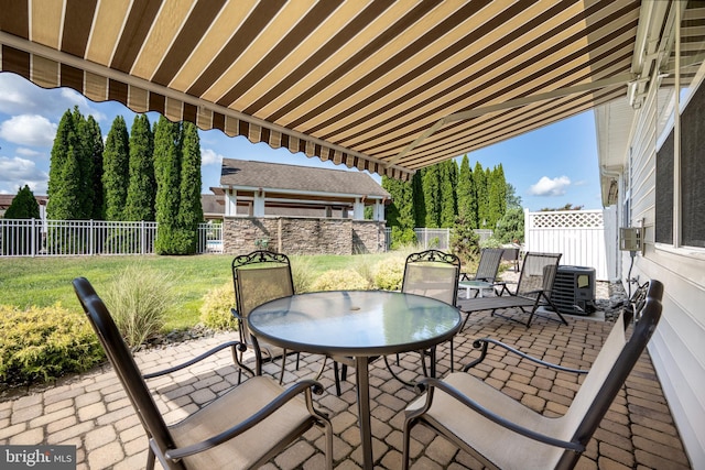 view of patio / terrace with cooling unit, outdoor dining area, and a fenced backyard