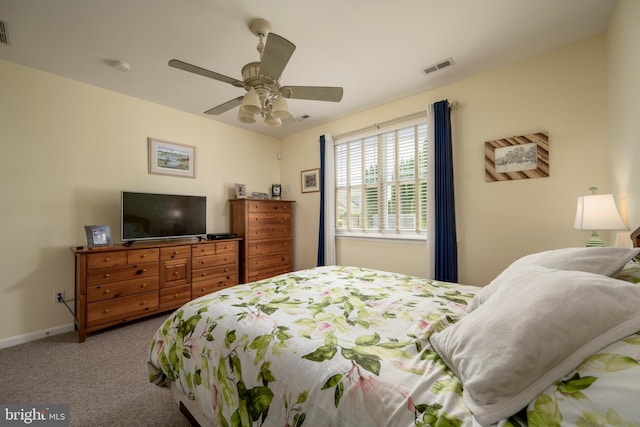 carpeted bedroom featuring visible vents, ceiling fan, and baseboards