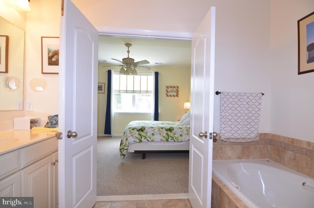 full bathroom with a ceiling fan, ensuite bath, a garden tub, tile patterned flooring, and vanity