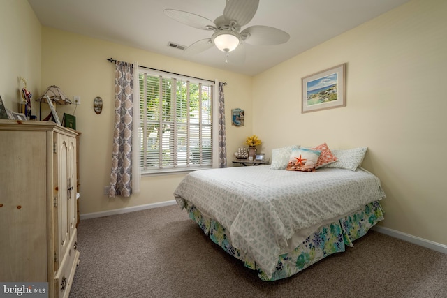 carpeted bedroom featuring visible vents, baseboards, and a ceiling fan