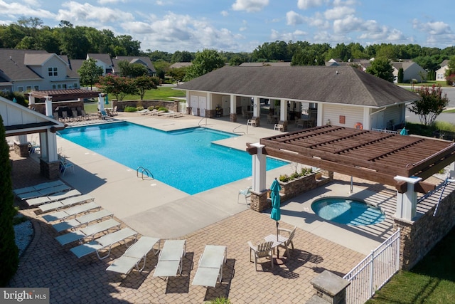 pool with a hot tub, fence, a pergola, and a water slide