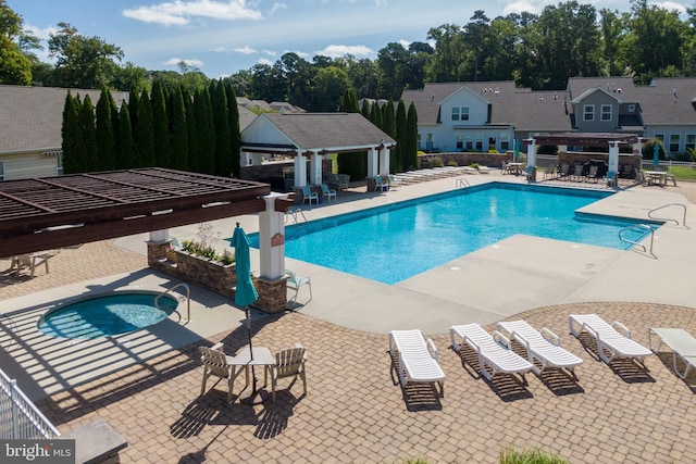 community pool with a hot tub, fence, a gazebo, a patio area, and a pergola