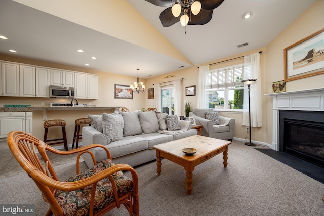 living area featuring recessed lighting, visible vents, a fireplace with flush hearth, carpet flooring, and vaulted ceiling