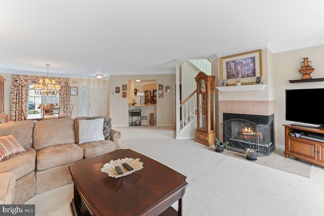 living room featuring ornamental molding, a tile fireplace, light colored carpet, and stairway