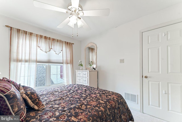 carpeted bedroom featuring visible vents and ceiling fan