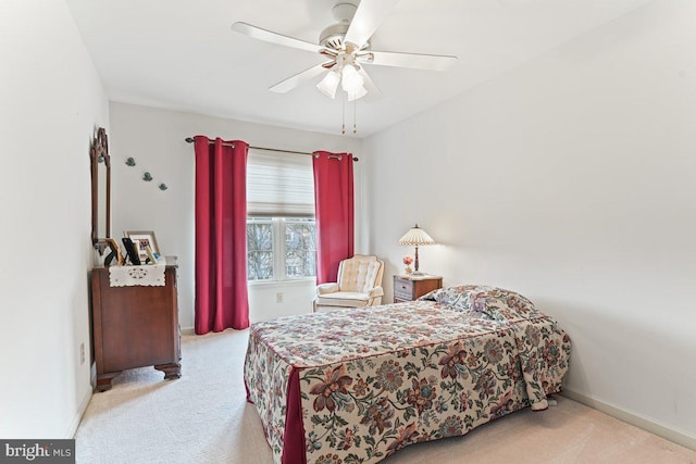 carpeted bedroom featuring ceiling fan and baseboards