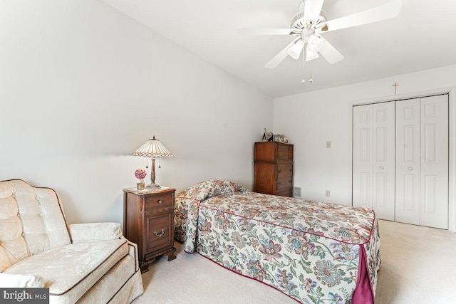 carpeted bedroom featuring ceiling fan and a closet