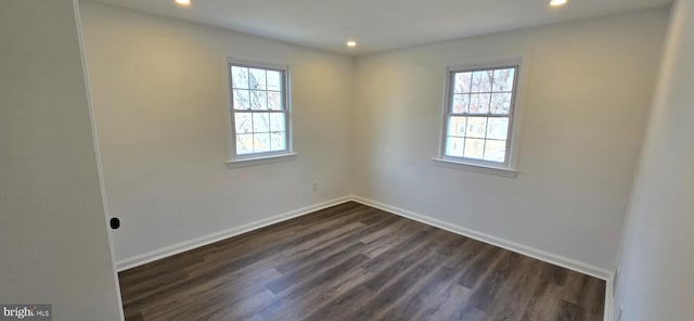 unfurnished room featuring recessed lighting, dark wood finished floors, and baseboards