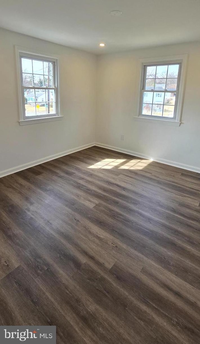 unfurnished room featuring dark wood-style floors, baseboards, and recessed lighting