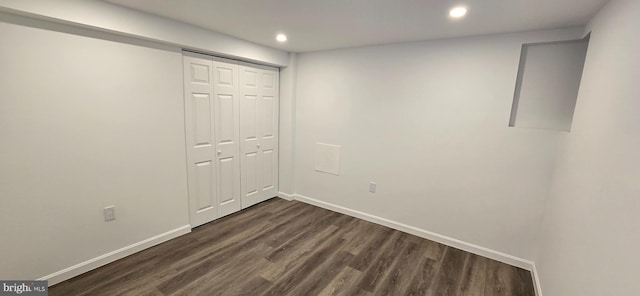 unfurnished bedroom featuring recessed lighting, a closet, dark wood finished floors, and baseboards