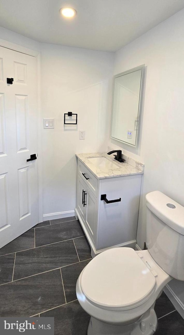 bathroom featuring recessed lighting, toilet, wood tiled floor, vanity, and baseboards