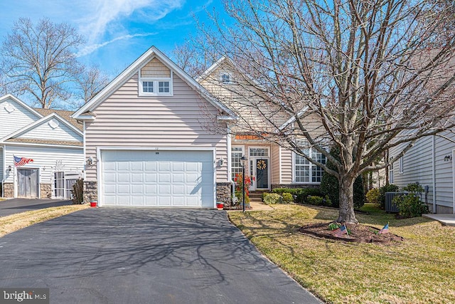 view of front facade featuring a front yard, driveway, and an attached garage