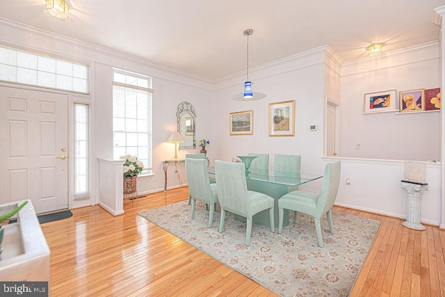 dining room featuring ornamental molding and wood-type flooring