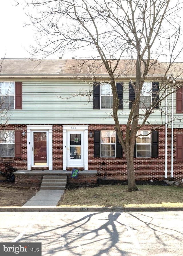 view of property with brick siding