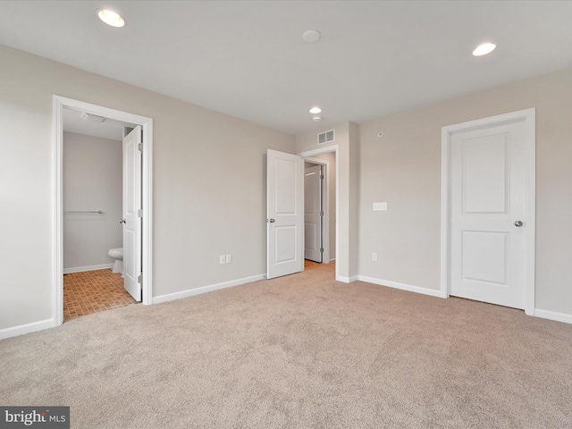 unfurnished bedroom featuring carpet, recessed lighting, visible vents, connected bathroom, and baseboards