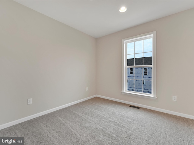 empty room with recessed lighting, carpet flooring, visible vents, and baseboards