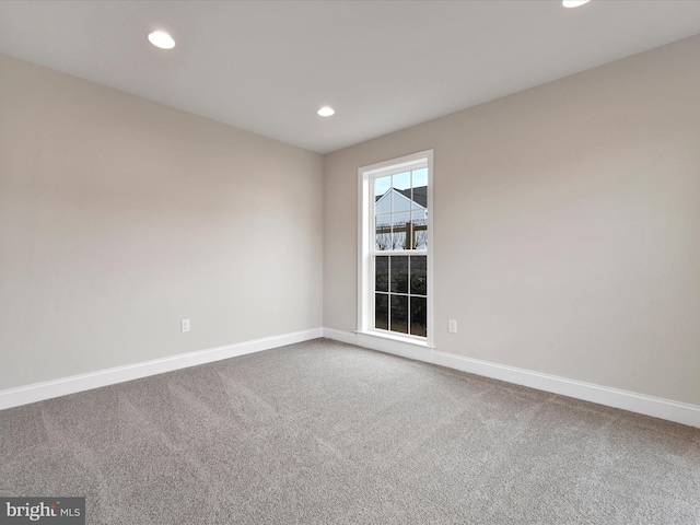 carpeted empty room with recessed lighting and baseboards