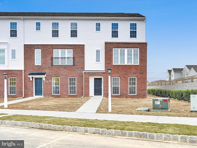 view of property featuring brick siding