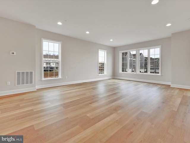 unfurnished living room featuring light wood-type flooring, baseboards, visible vents, and recessed lighting