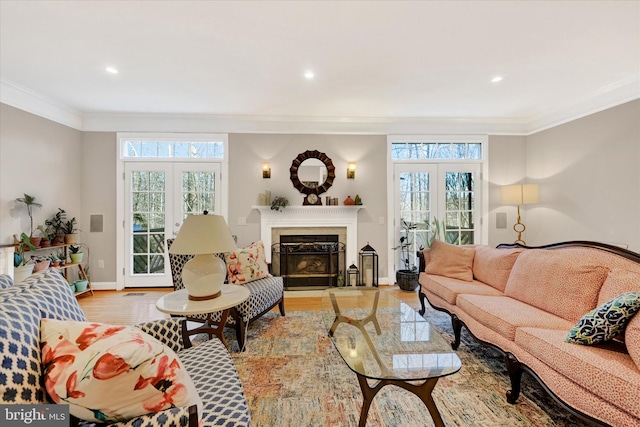 living room featuring light wood-type flooring, crown molding, a wealth of natural light, and french doors