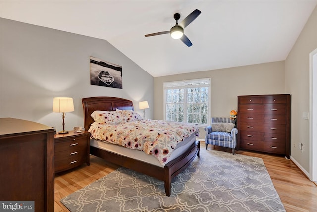 bedroom with lofted ceiling, ceiling fan, light wood-type flooring, and baseboards