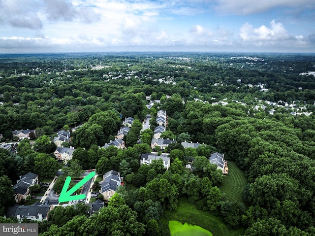 birds eye view of property with a view of trees