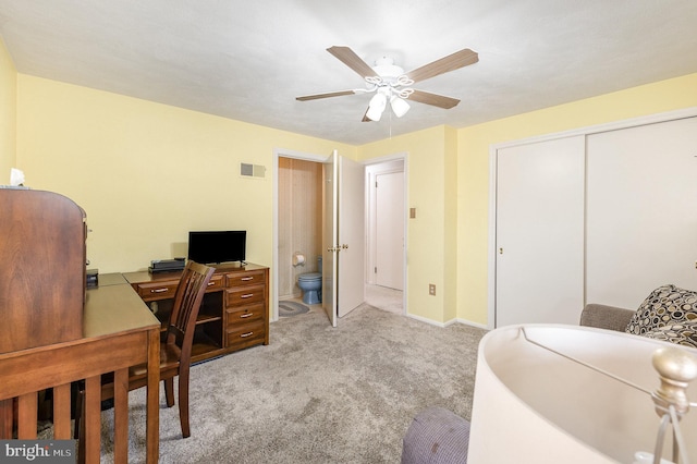 carpeted office space featuring visible vents, baseboards, and a ceiling fan