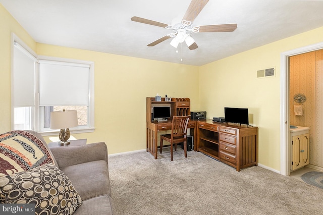 carpeted home office featuring a ceiling fan, baseboards, and visible vents