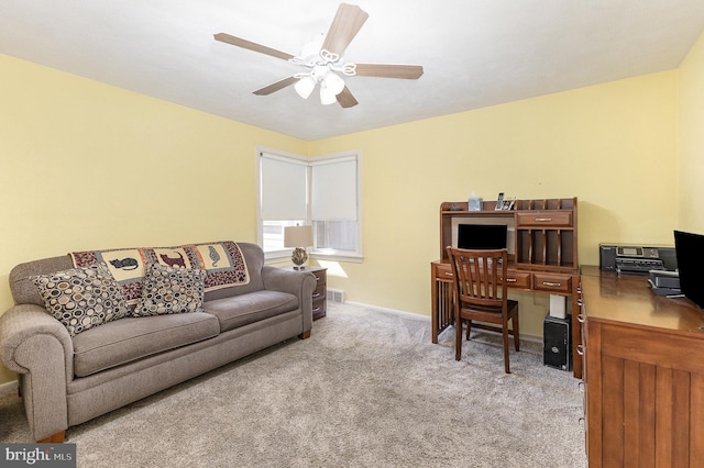 carpeted office space featuring visible vents, baseboards, and a ceiling fan