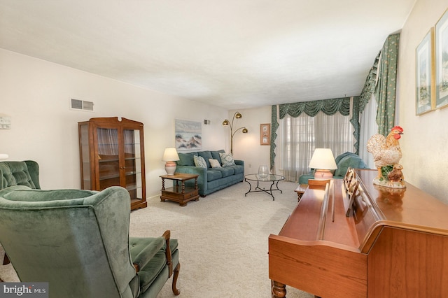 living room featuring visible vents and carpet