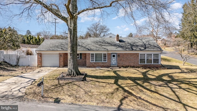 cape cod house with a front lawn, fence, concrete driveway, a garage, and brick siding