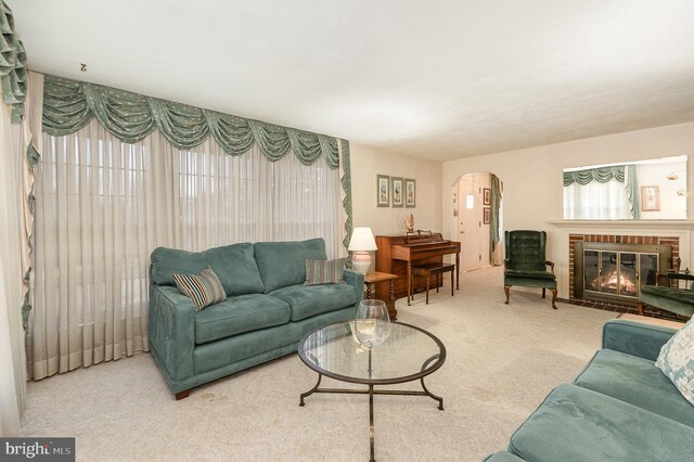 living room with arched walkways, a brick fireplace, and carpet floors