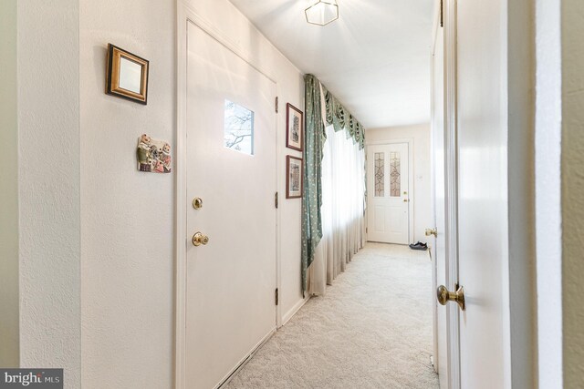 hallway featuring light carpet