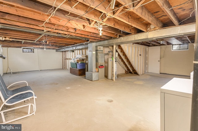 basement with stairs, gas water heater, and washer / clothes dryer