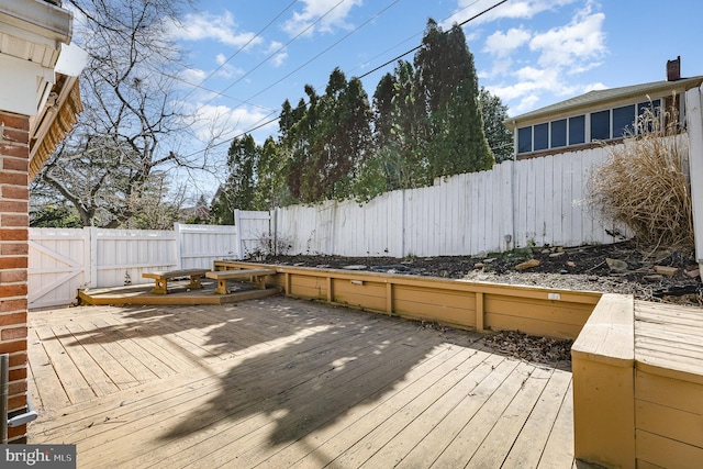 wooden terrace featuring a fenced backyard