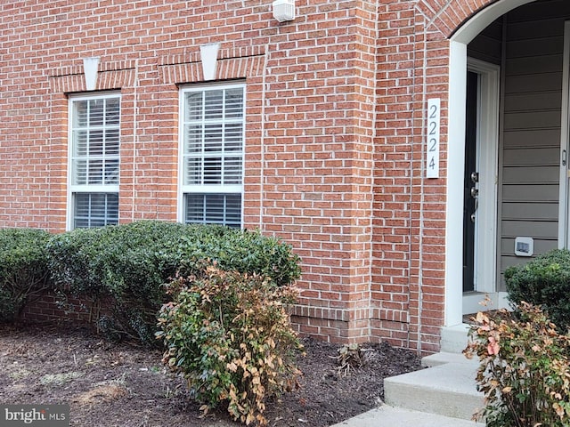 property entrance with brick siding