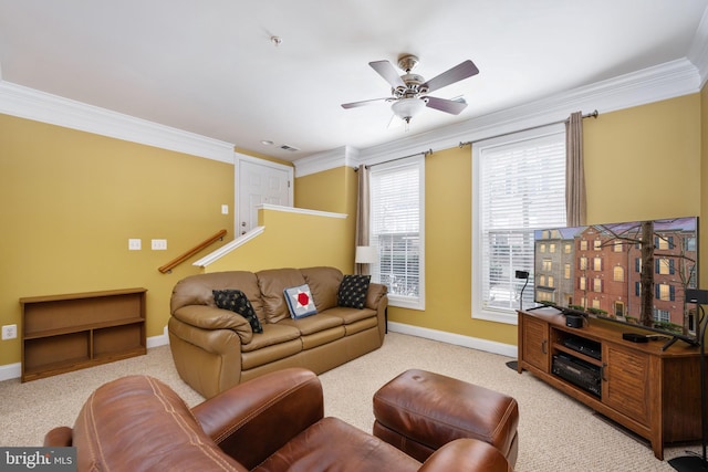 carpeted living room with baseboards, ornamental molding, and a ceiling fan