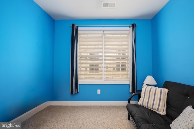 unfurnished room featuring carpet floors, visible vents, and baseboards