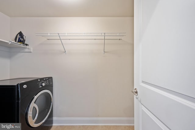 laundry room with washer / clothes dryer, baseboards, and laundry area