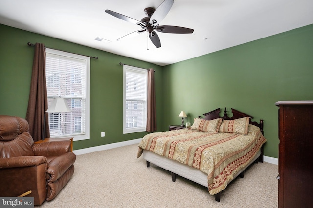 carpeted bedroom featuring baseboards, visible vents, and ceiling fan