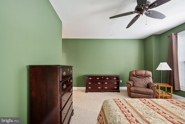 carpeted bedroom with a ceiling fan and baseboards