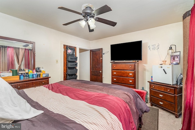 bedroom with a ceiling fan and carpet