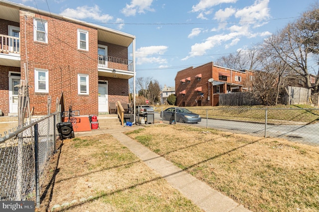 view of yard featuring entry steps and fence