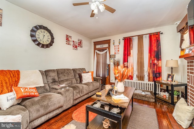 living area featuring a ceiling fan and hardwood / wood-style flooring