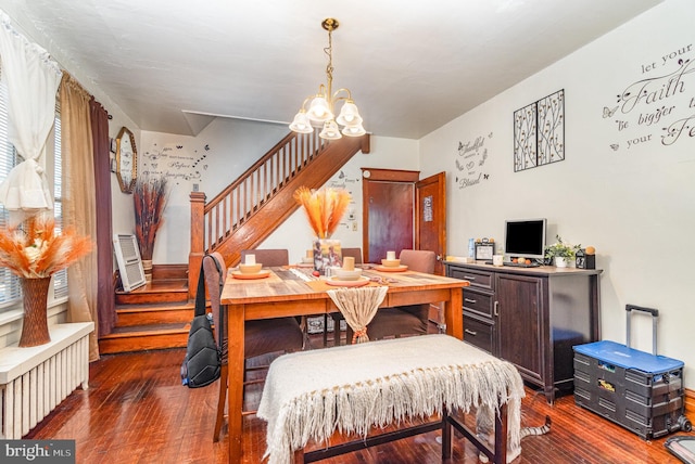 dining room featuring hardwood / wood-style floors, a chandelier, stairs, and radiator heating unit