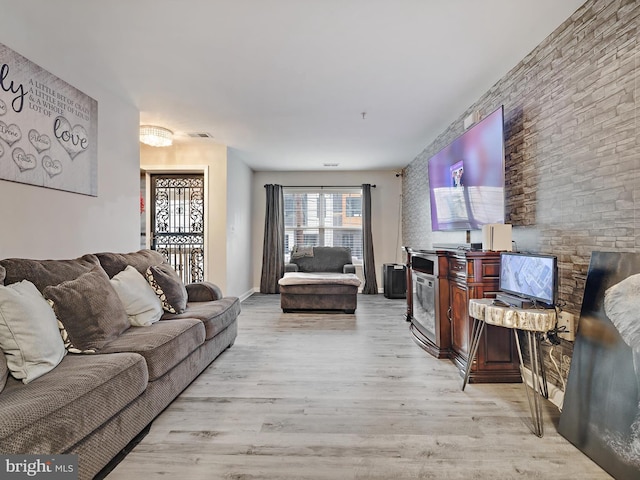 living room featuring visible vents and light wood-style flooring