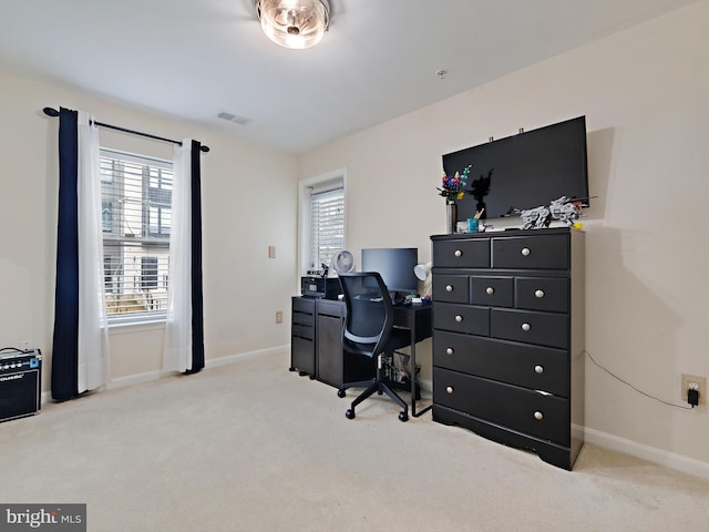 carpeted home office with visible vents and baseboards