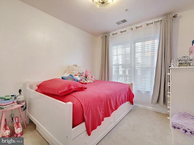 carpeted bedroom featuring visible vents and baseboards