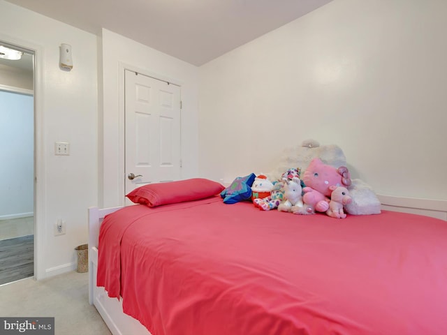 carpeted bedroom featuring baseboards