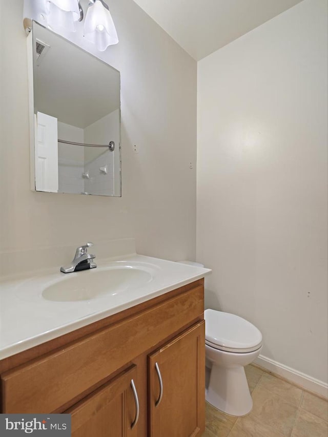 bathroom featuring toilet, visible vents, vanity, tile patterned floors, and walk in shower